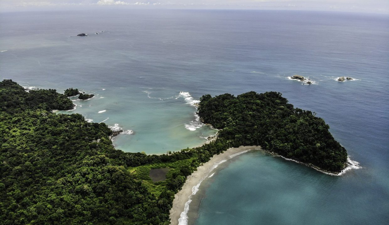 Aerial view of a forested Costa Rican coastline and cove